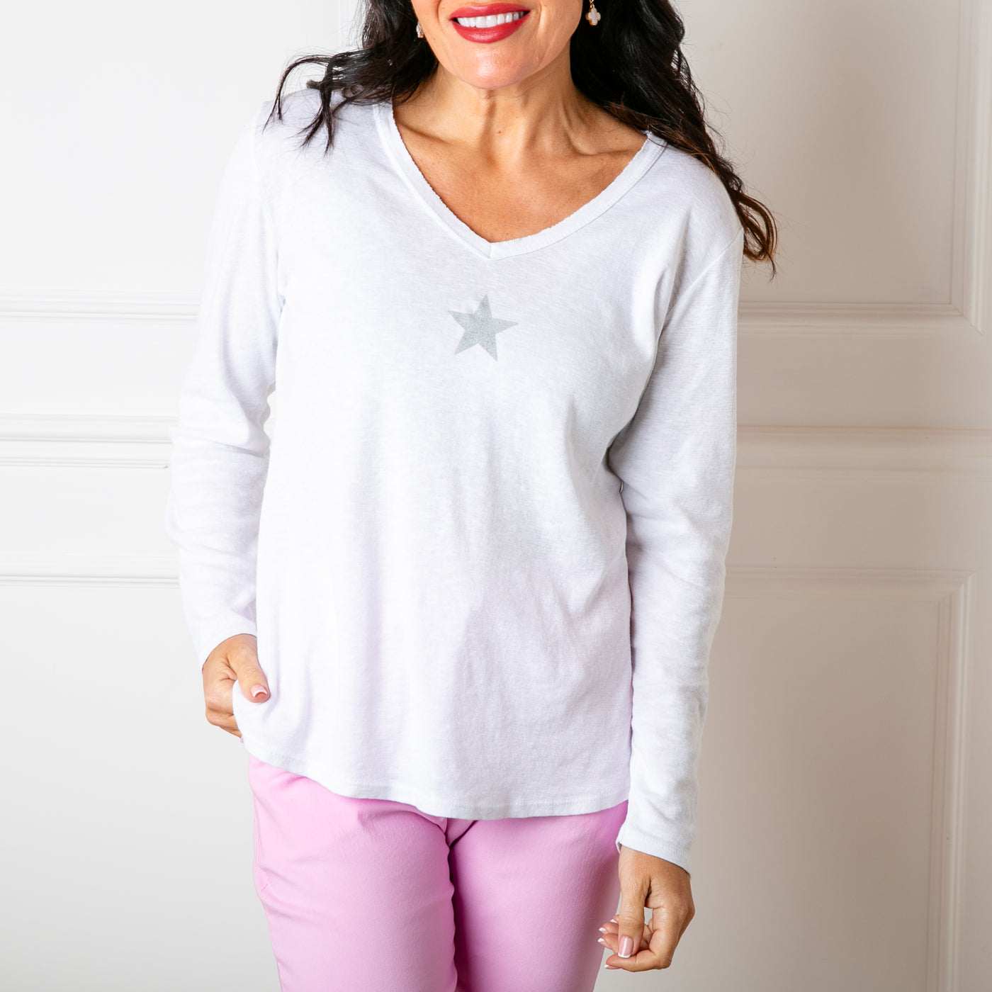 The white Long Sleeve Star Top made from a stretchy cotton material 